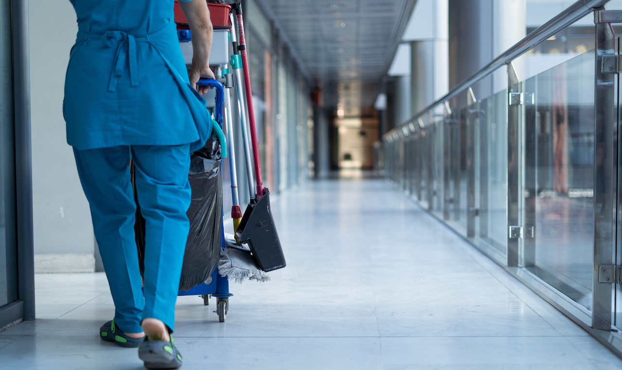Woman walking while doing commercial cleaning in a Clark County Nevada office