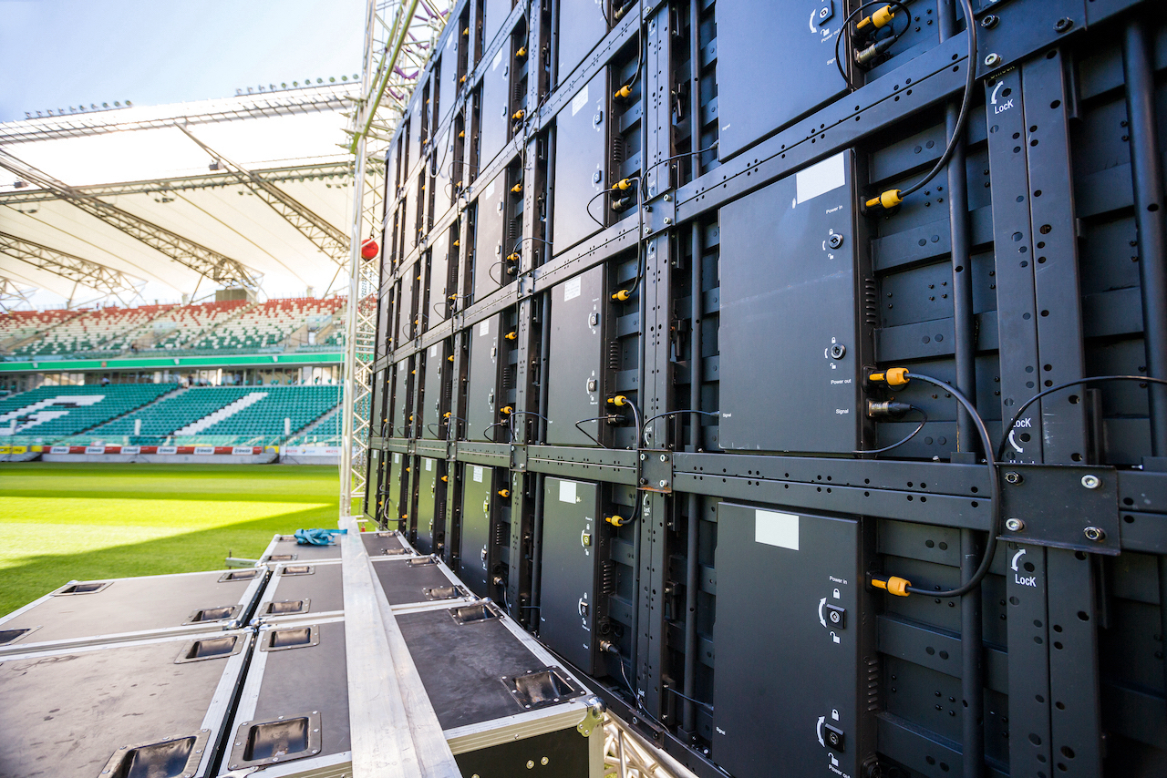 Giant LED screen in sports stadium seen from behind