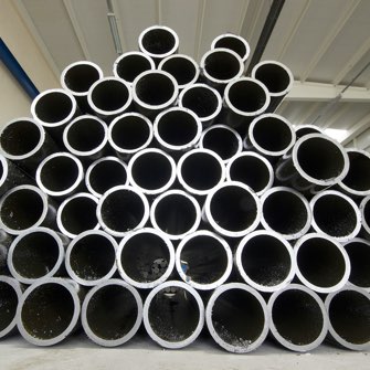 cargamento de diferentes tipos de tuberías de acero en camiones siendo transportadas en México